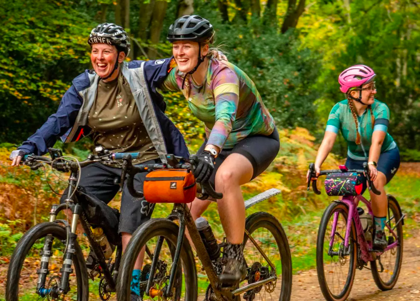 Friends cycling through the forest. How to get started with cycling.